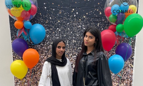 Two students celebrating their results